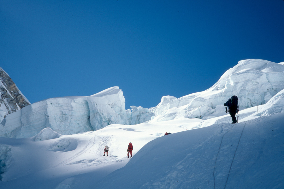 A high altitude climber on a snowy peak
